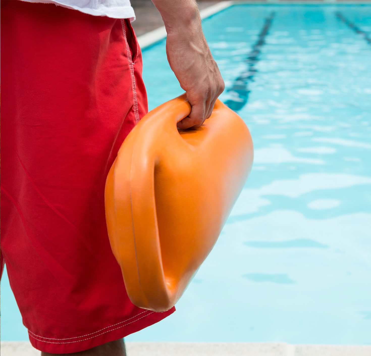 Pool lifeguard standing in front of pool