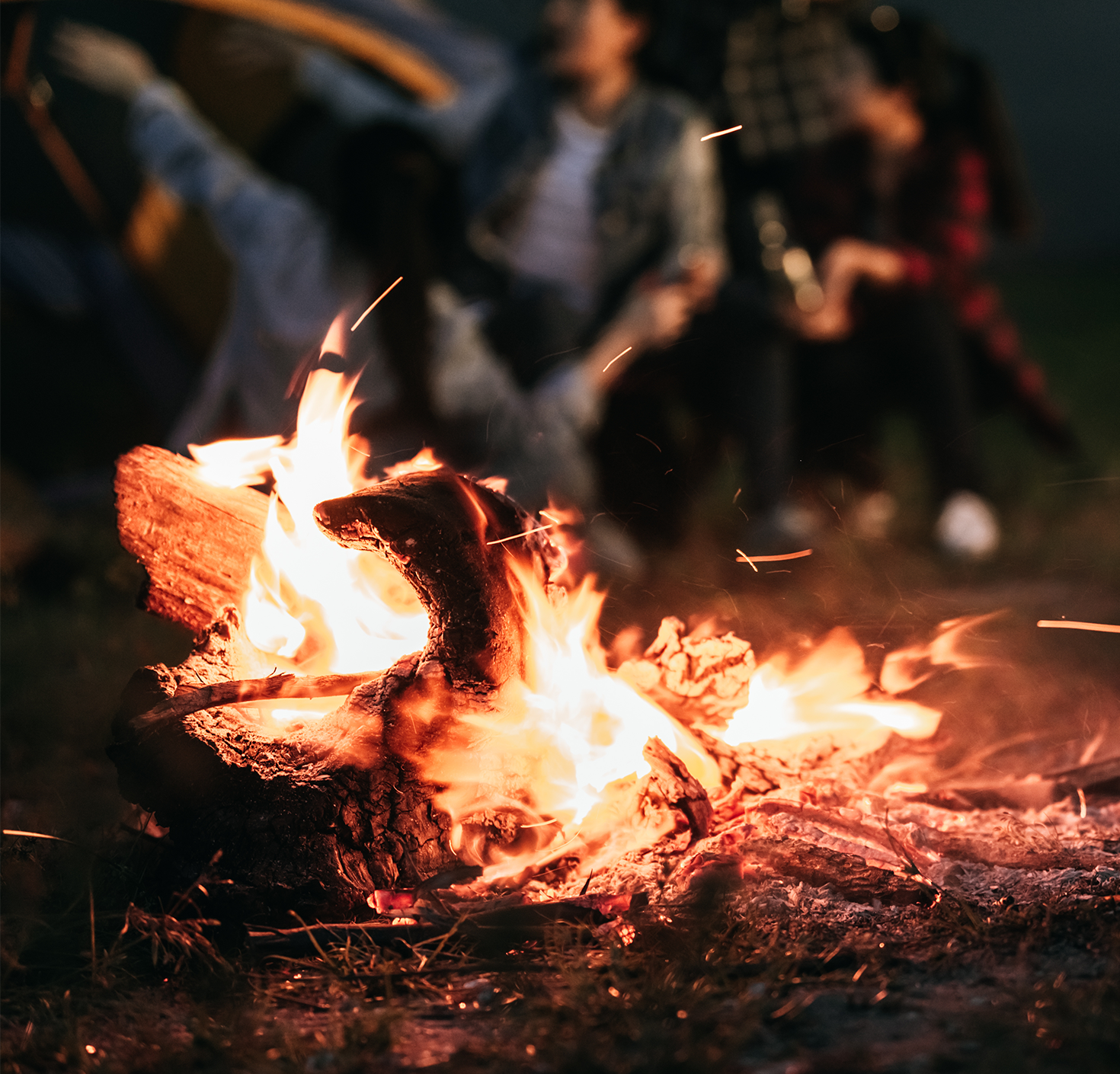 Small fire with people sitting in the back