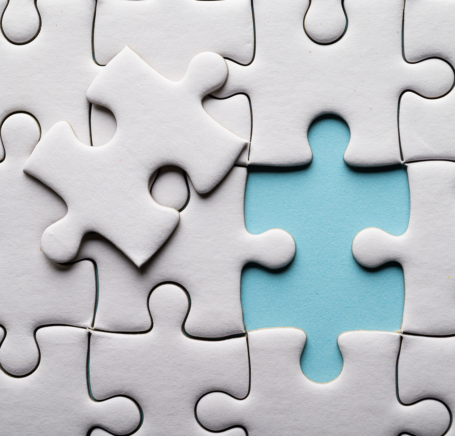 Puzzle piece on top of puzzle